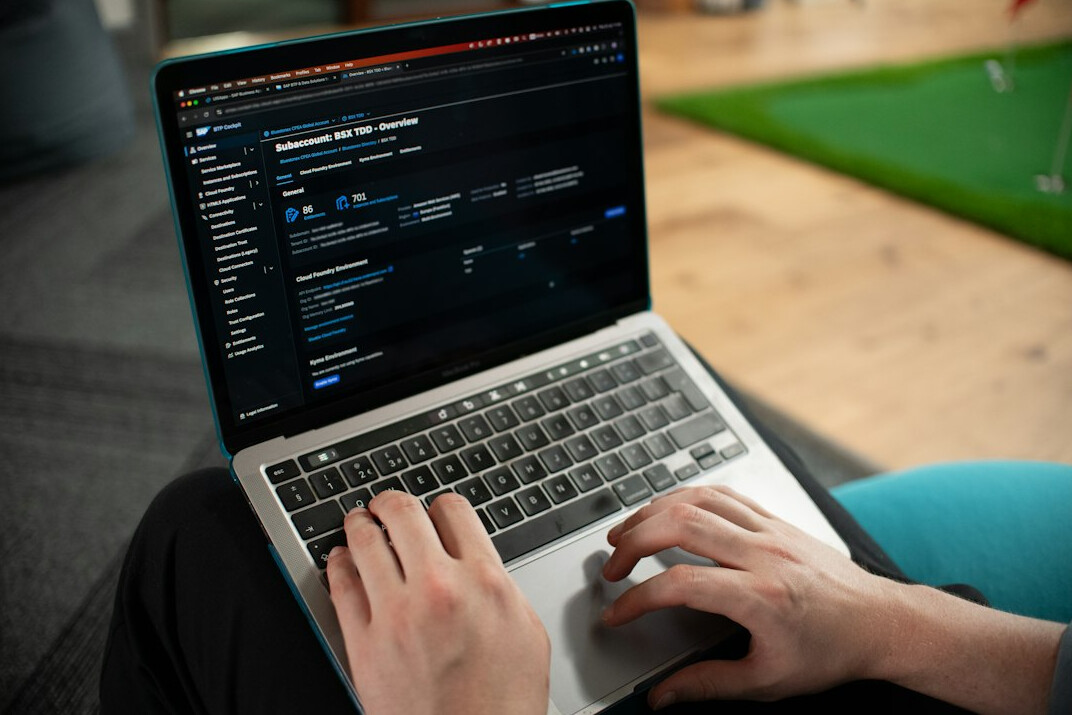 person coding on laptop