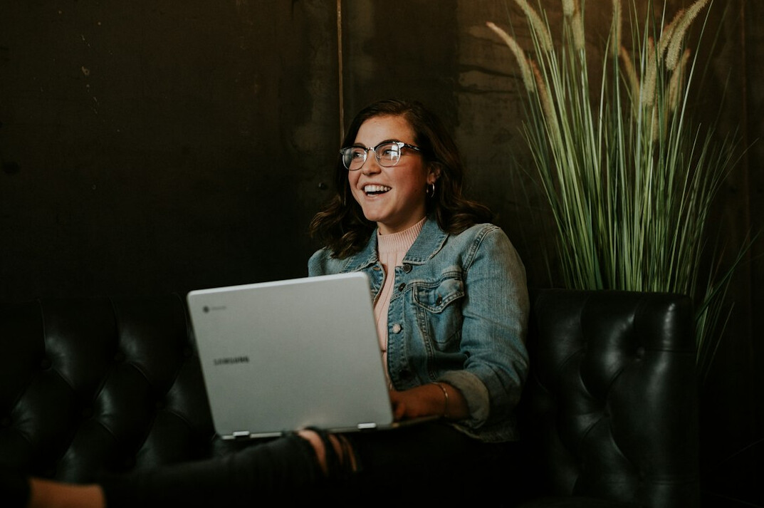 happy person coding on laptop