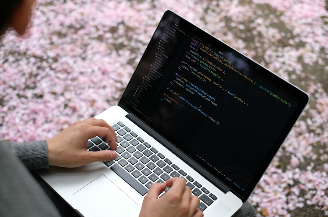happy person coding on laptop